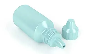 Light blue eyedrop bottle, uncapped, lying on its side against a white background.